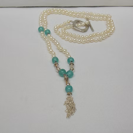 White pearl necklace with blue beads